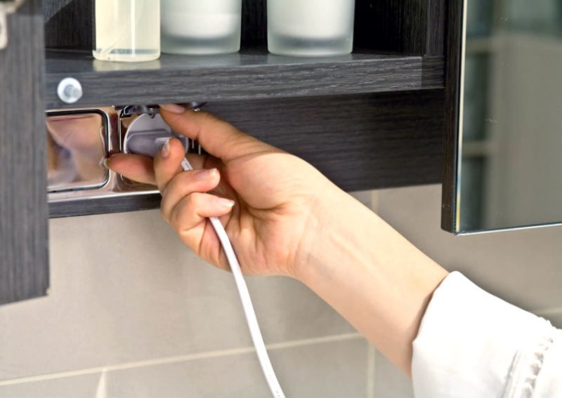 Waterproof outlet under the shelf in the bathroom