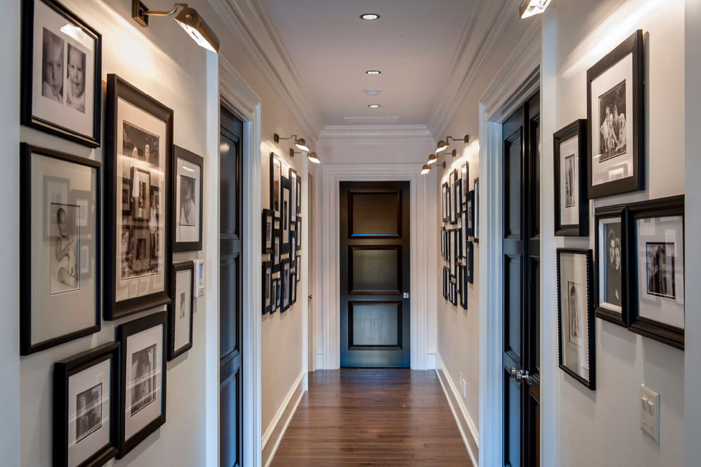 Black door at the end of a long corridor