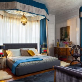 Blue curtains in the bedroom interior