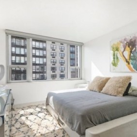 minimalism bedroom with a bed by the window