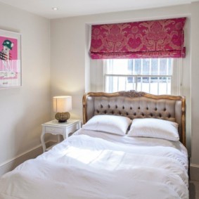 small bedroom with a bed by the window