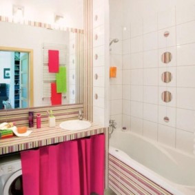 Pink curtain under the countertop in the bathroom