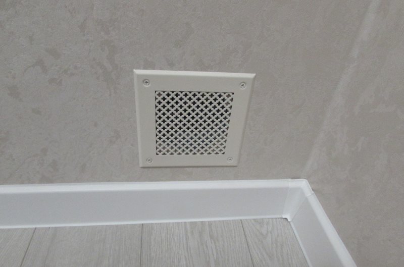 Ventilation grille between living room and bedroom with no window