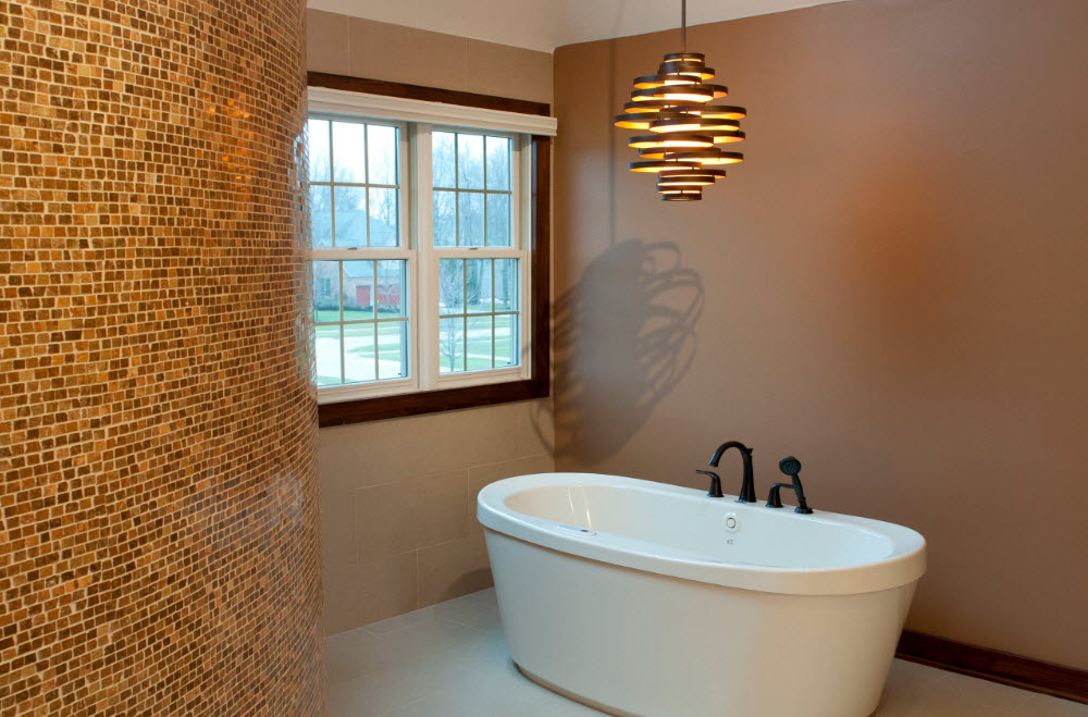 Black faucet mounted on a white acrylic bathtub