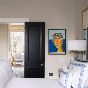 Black door in a bright bedroom