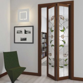 Harmonica door on a wooden frame with stained-glass windows