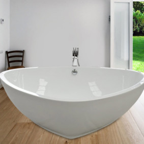 Triangular bathtub on a wooden floor