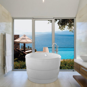 Round bath in front of a large window