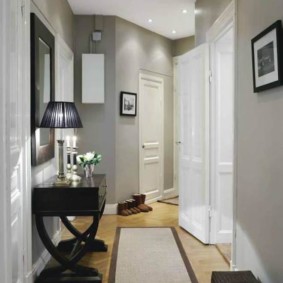 Narrow corridor with a bend in the apartment of a brick house