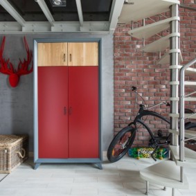 Metal cabinet in the entrance area of ​​the studio apartment