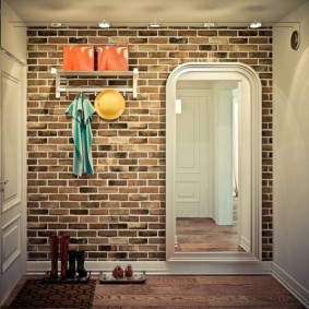 Wallpaper under a brick in the interior of the corridor