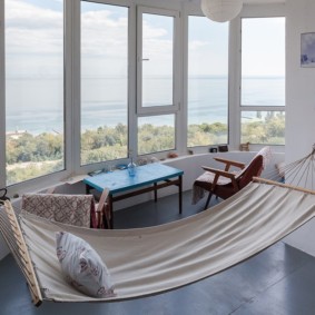 Hammock on a loggia with an arched wall