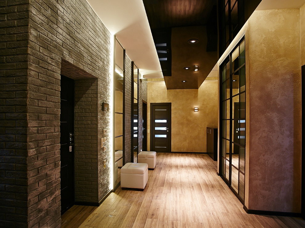 A pair of light poufs in the hallway with brickwork