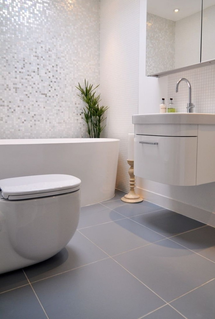 Gray tile on the floor in the combined bathroom