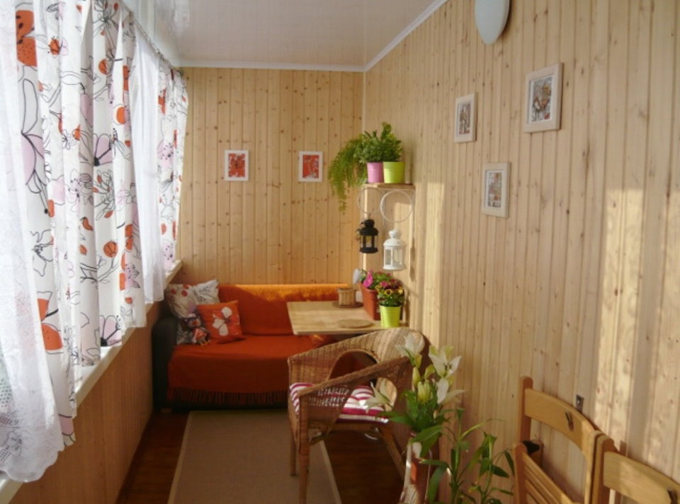 Bright curtains on the balcony with a sofa