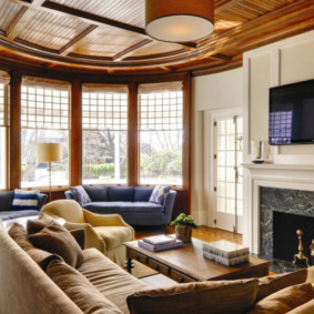 Arc-shaped sofa in the bay window of a country house