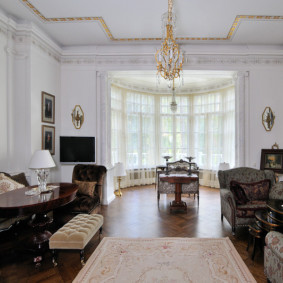 Chandelier with gilding on a white ceiling