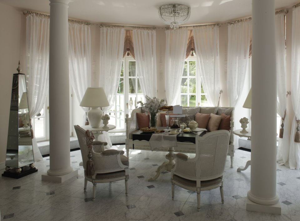 Columns in a bay window of a country house with a terrace