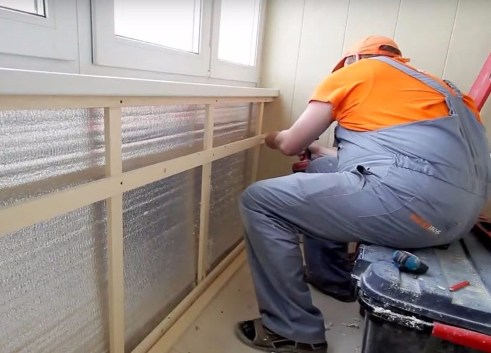 Installation à faire soi-même d'une caisse en bois sous les panneaux du balcon