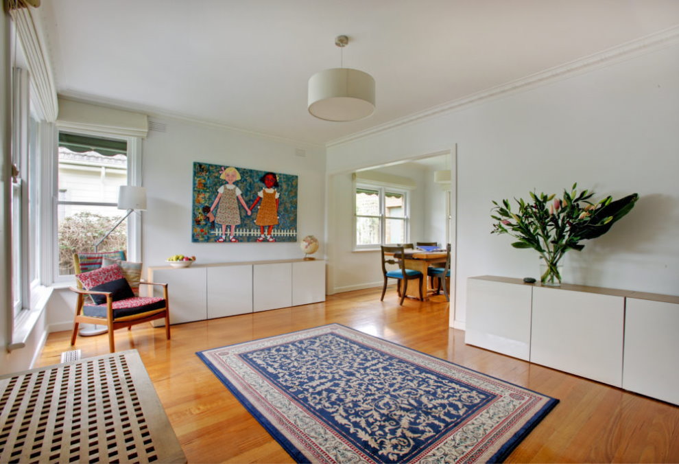 Rectangular carpet on the floor of a bright living room