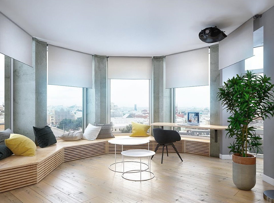 Roller blinds on the windows of a bay window in a modern apartment