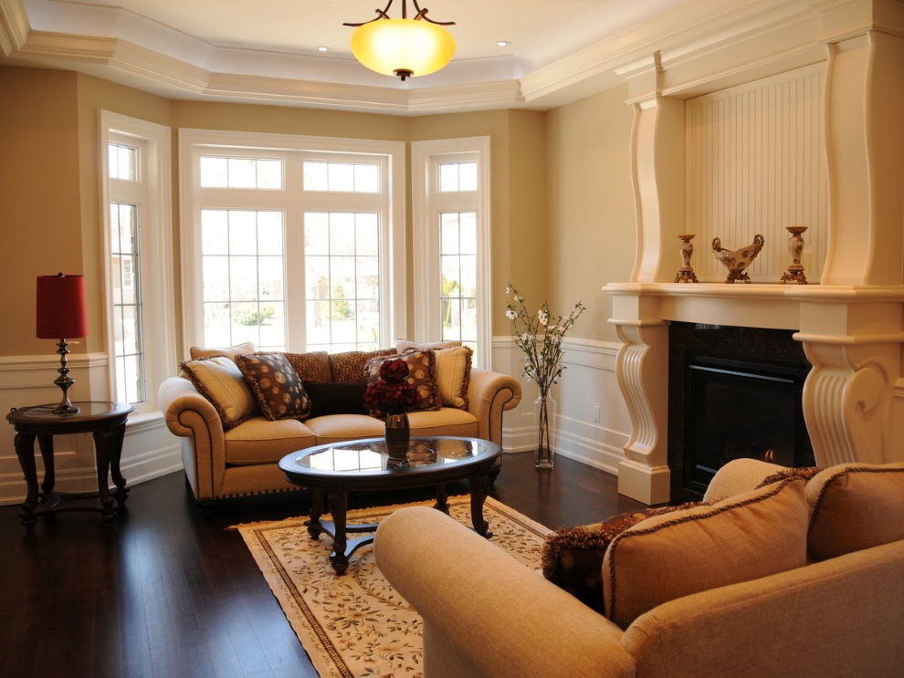 Fireplace in the living room of a country house with a bay window