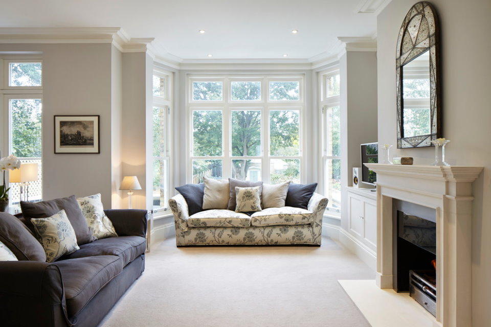 Bay window in the interior of a private house with a fireplace