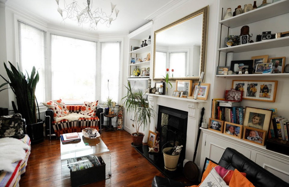 Indoor plants in the living room bay window with fireplace