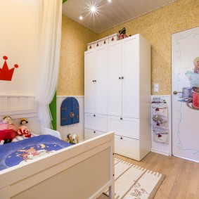 White wardrobe in the corner of the children's bedroom