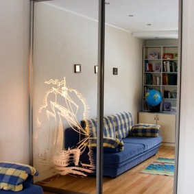 Reflection of a blue sofa in the mirrored cabinet doors