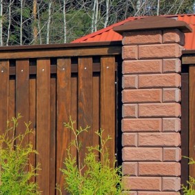 Blank fence on brick poles