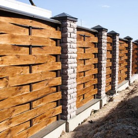 Boards in wicker fence sections