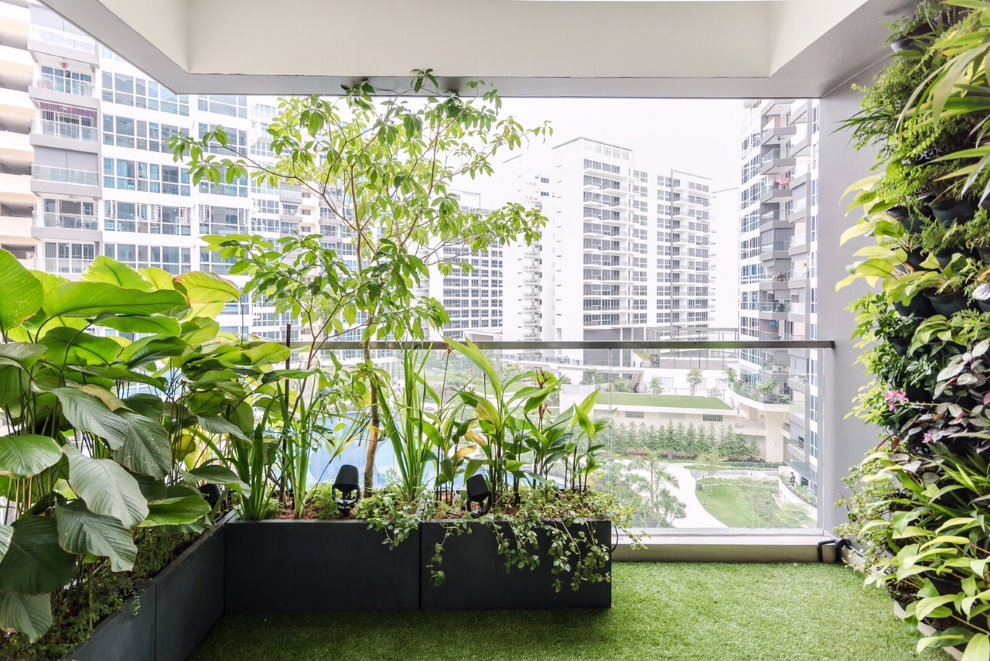 Green plants on the loggia of an apartment building