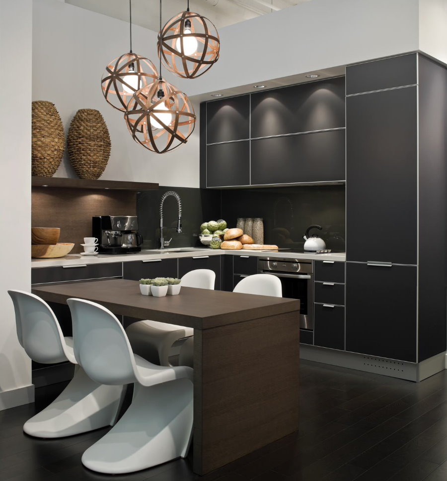 White chairs on the dark floor of a modern kitchen