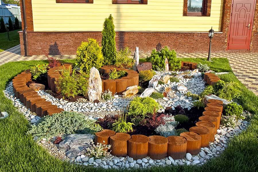 Small rock garden in front of the facade of the house