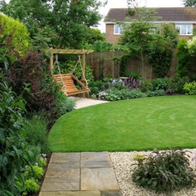 English lawn in front of a garden swing