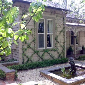 A small pond with a fountain in the yard