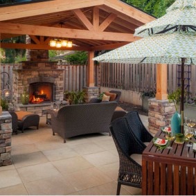 Brick fireplace in a wooden arbor