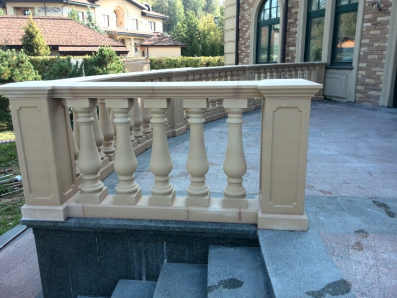 Decorative concrete fence near a country house