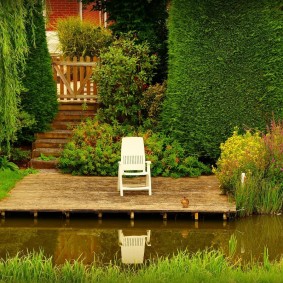 Wooden bridge on the shore of a pond