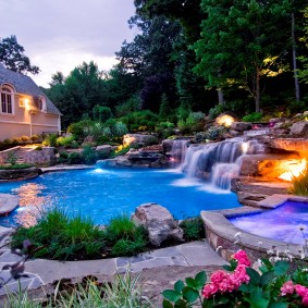 Artificial pond with a waterfall in a rural area