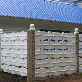 White balls on the pillars of a concrete fence