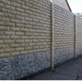 Artificial stone on the surface of a concrete fence