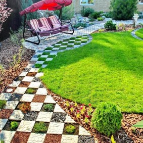 Garden swing on the site with paving slabs