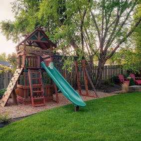 Game house with a slide in the garden