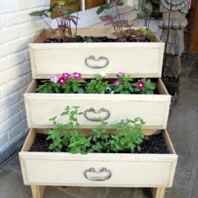 Tall flower bed of old boxes