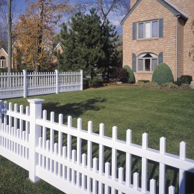 White fence on the border of the garden